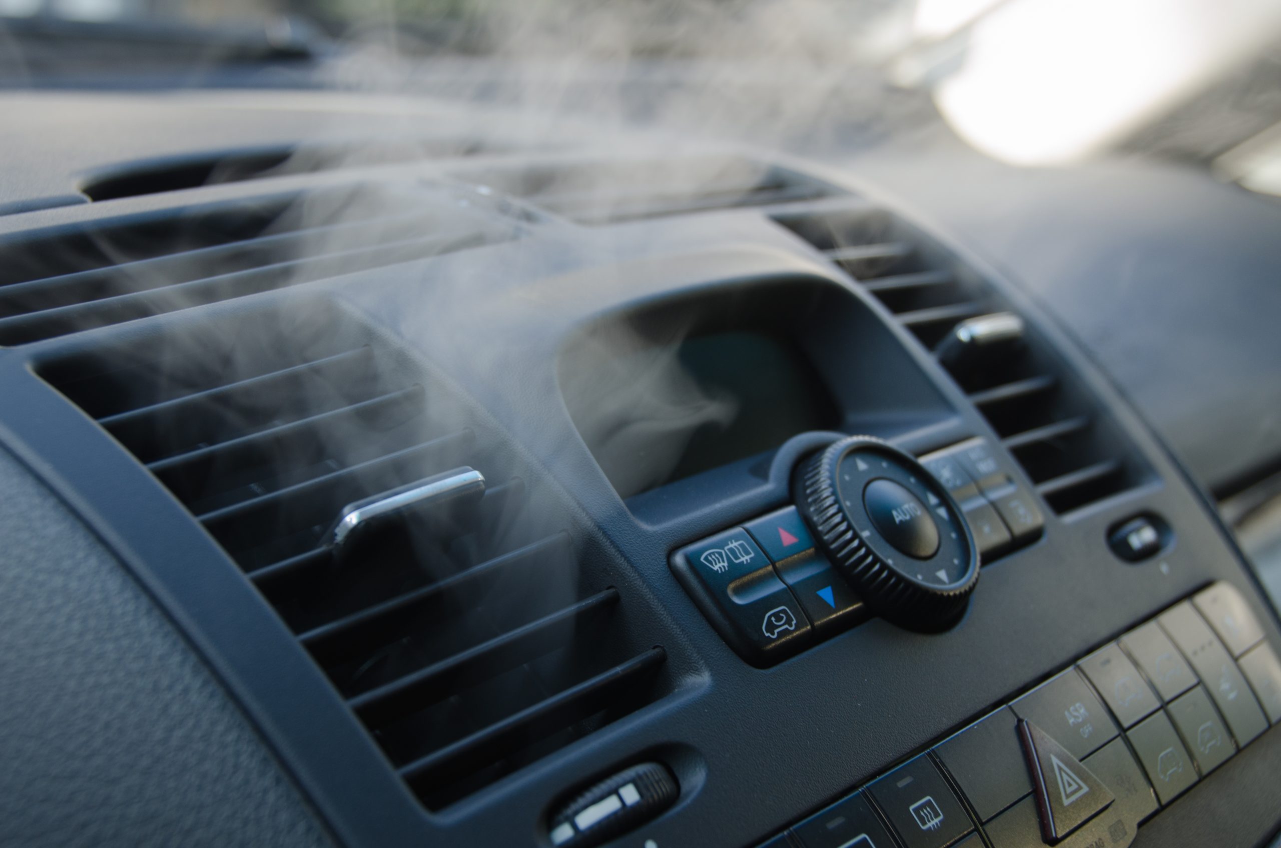 A photo of a car's AC vent with steam