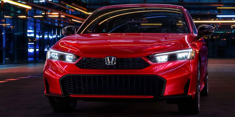 A photo of the front grille of a red 2025 Honda Civic