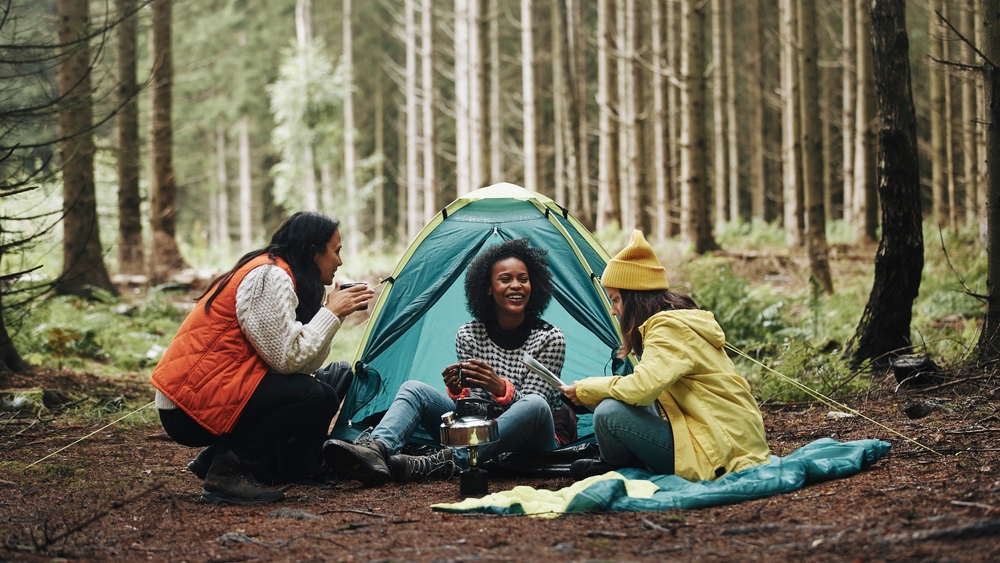 A group of friends camping in the woods.